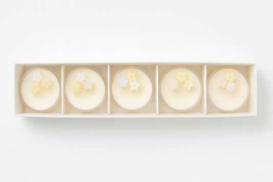 Five candles in a decorative box on a white background